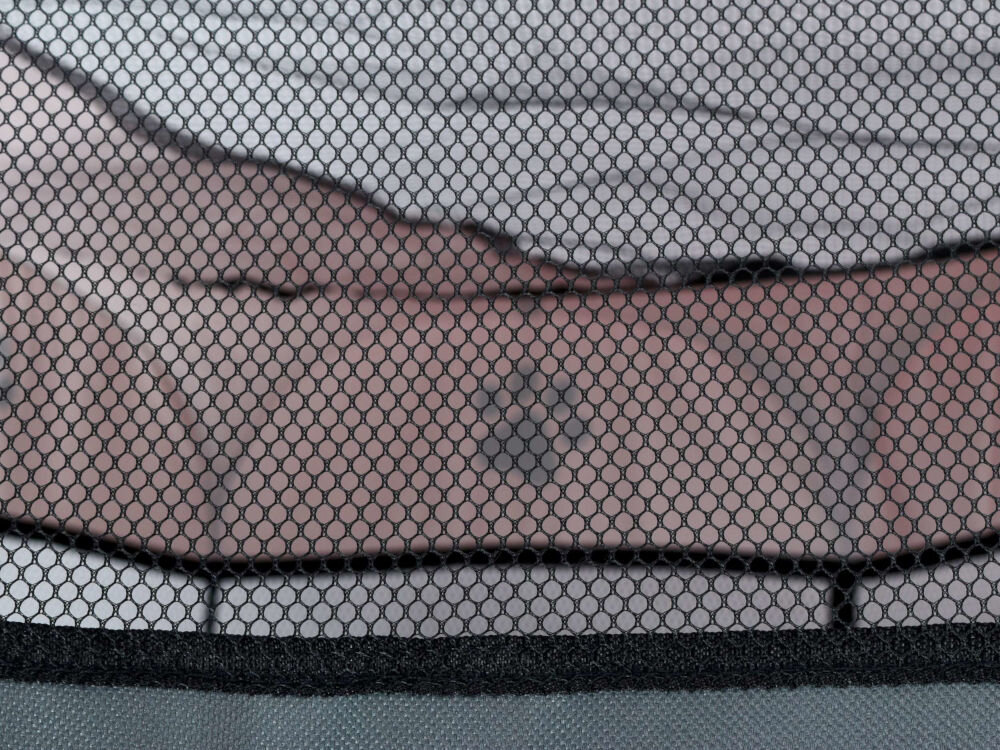 Kojec ZWIERZOPASJA z siatką wentylacyjną chroniącą przed owadami i zapewniającą cyrkulację powietrza Zbliżenie na siatkową wentylacyjną ścianę kojca, z rozmytym tłem wskazującym na wnętrze pomieszczenia.