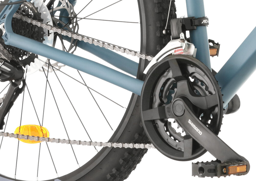 Rower górski MTB INDIANA X-Pulser 3.7 M21 27.5 cala męski Niebiesko-czarny zbliżenie na korbę wolnobieg i łańcuch lekka wydajna konstrukcja korby korba SHIMANO typu FC-TY301 kaseta SHIMANO typu CS-HG318134-8S solidność wytrzyma bardzo duży nacisk na pedały
