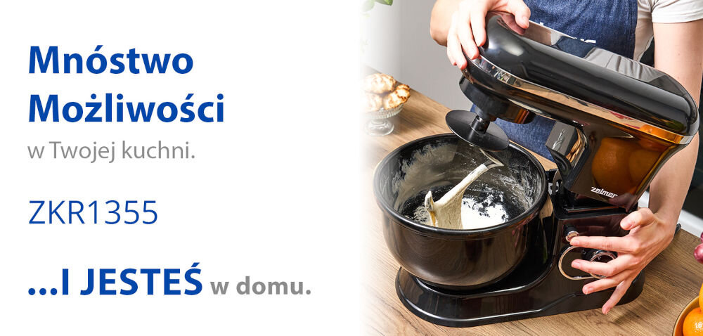Robot planetarny ZELMER ZKR1355 1200W mnóstwo możliwości jasne tło robot w czarnym kolorze ciasto w misie dłoń przytrzymująca przycisk  