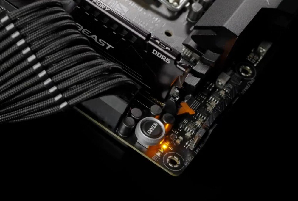 Płyta główna ASUS ROG STRIX B860-F Gaming WIFI Detal laminatu z okrągłym przyciskiem opisanym jako 'START' oraz świecącą na pomarańczowo diodą LED