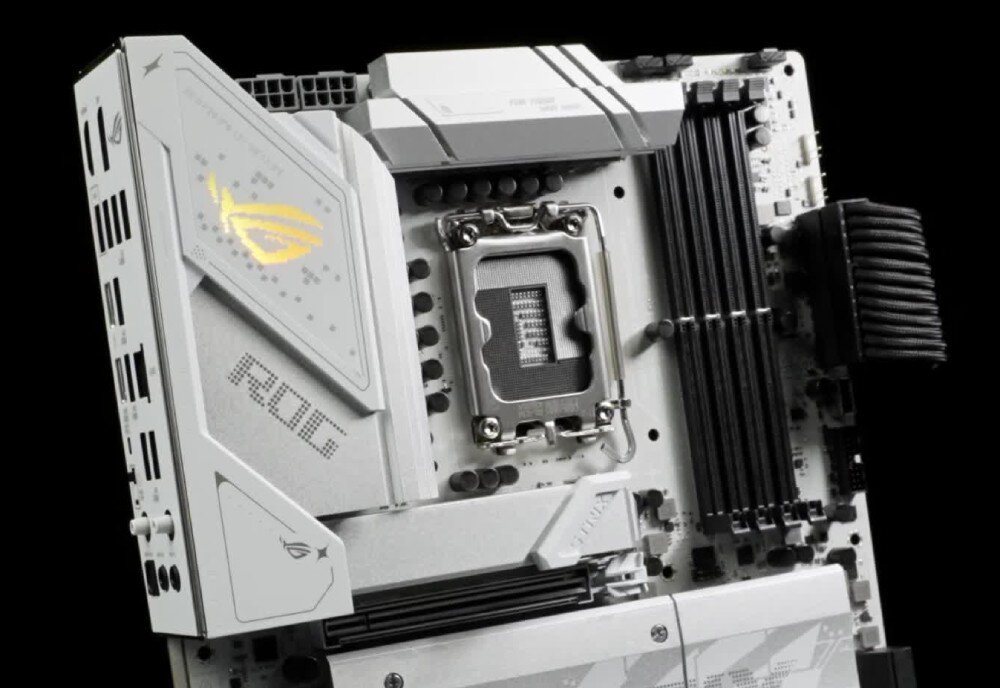 Płyta główna ASUS ROG Strix B860-G Gaming WiFi Zbliżenie na górną część płyty z gniazdem procesora, czterema czarnymi slotami pamięci RAM oraz srebrną osłoną z podświetlonym na żółto logo ROG, procesory, kompatybilność