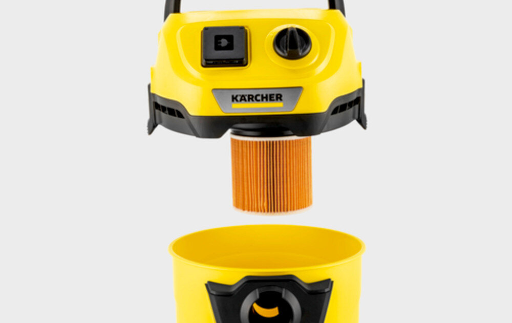Obraz przedstawia żółty odkurzacz z widocznym filtrem i pojemnikiem na kurz. Na odkurzaczu znajduje się logo \'KARCHER\'.