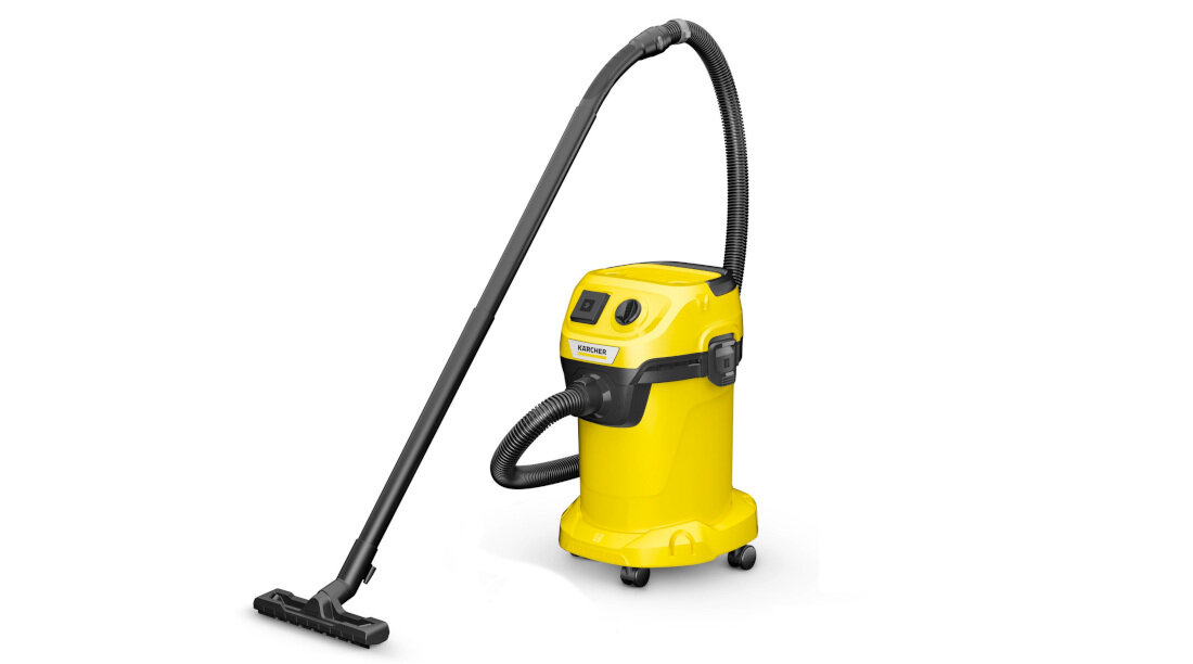 Żółty odkurzacz z czarnym wężem i ssawką, na kółkach, z widocznym logo KARCHER na przodzie.
