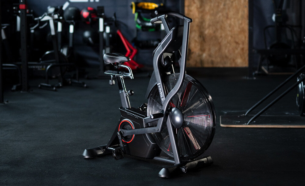 Rower powietrzny HMS MP5420 siłownia rower ustawiony po środku pomieszczenia połączenie ruchu pedałów i uchwytów poprawa wydolności oddechowej krążenia ogólnego samopoczucia zaawansowany rower powietrzny wszechstronny trening całego ciała w domu w użytku komercyjnym