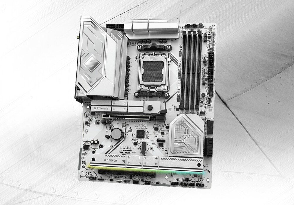 Płyta główna ASROCK B850 Steel Legend WiFi Widok z góry na płytę główną komputera z srebrnymi radiatorami i czarnymi gniazdami na białym laminacie, opis