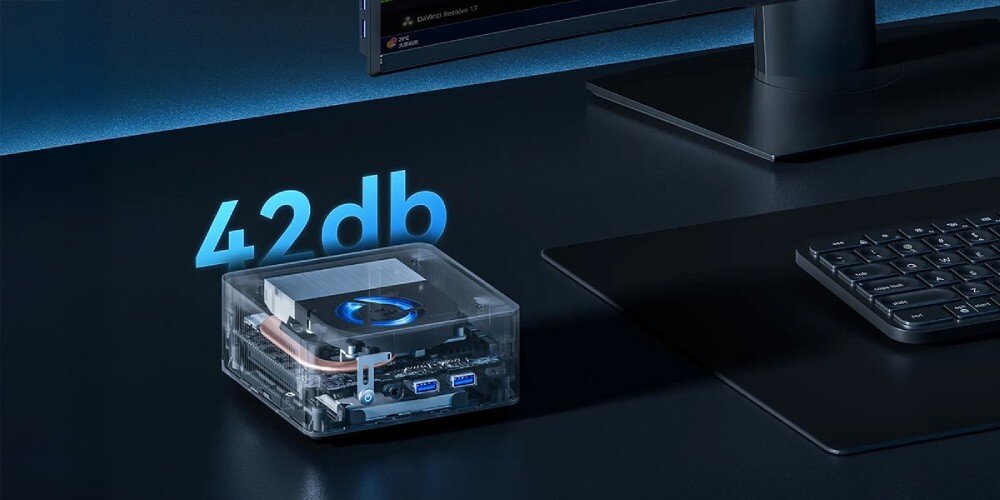 Komputer QOOBE II AP1215U Przezroczysty mini PC z podświetleniem wentylatora i widocznymi podzespołami, obok wyświetlona liczba '42 db', łączność, Wi-Fi 6, Bluetooth 5.2, porty