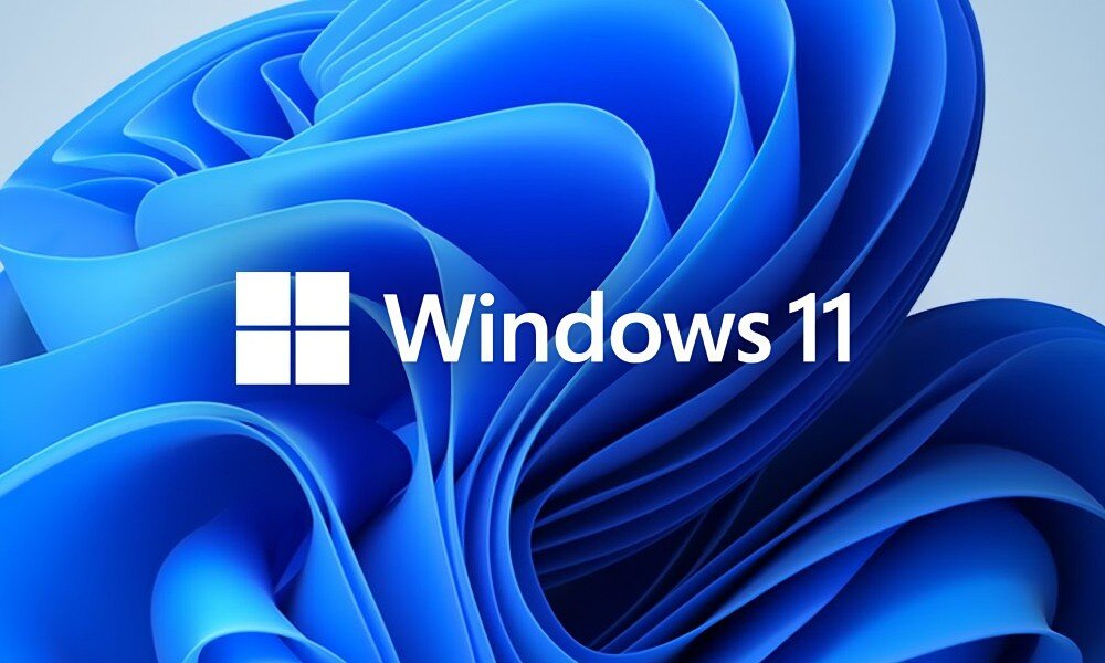 Komputer QOOBE U155H Logo systemu Windows 11 umieszczone na tle abstrakcyjnej niebieskiej grafiki przypominającej skręcone wstęgi, system, cechy, funkcje, wymiary