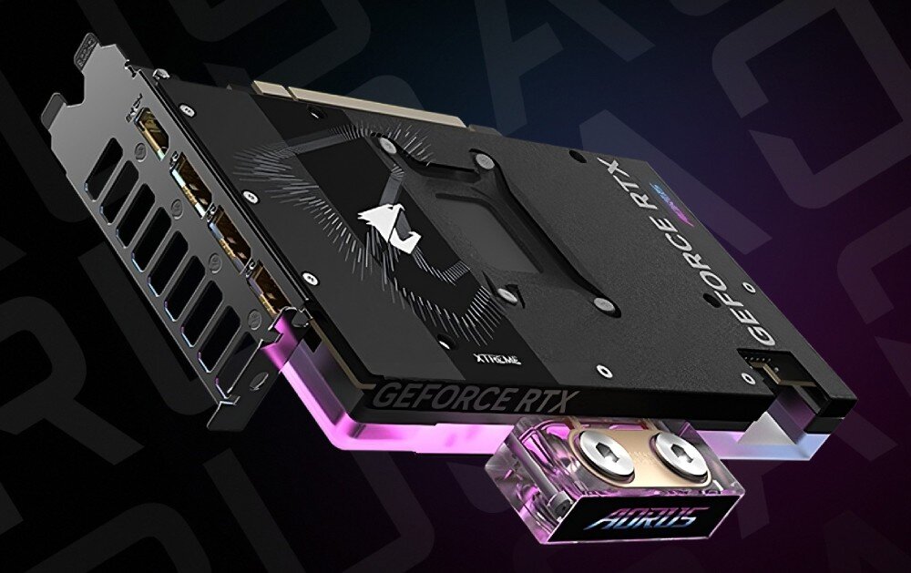 Karta graficzna GIGABYTE Aorus GeForce RTX 5080 Xtreme WaterForce WB 16GB Zbliżenie na część złączy do chłodzenia wodnego. Widoczne dwa porty wejścia i wyjścia cieczy, a wokół nich efektownie odbijające się światło RGB