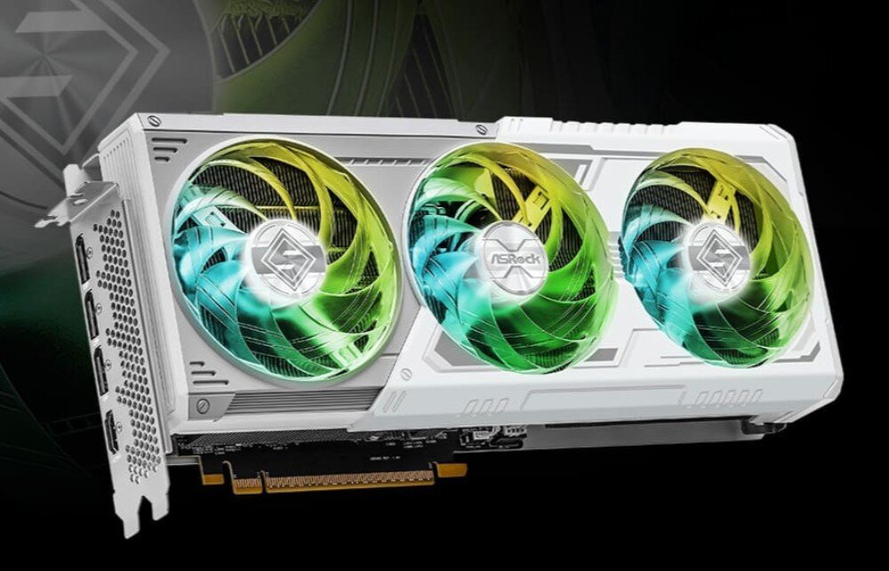 Komputer MAD DOG DIAXID605-W-I03DR32WH Biała karta graficzna ASRock Phantom Gaming z trzema dużymi wentylatorami, które świecą na zielono i niebiesko.