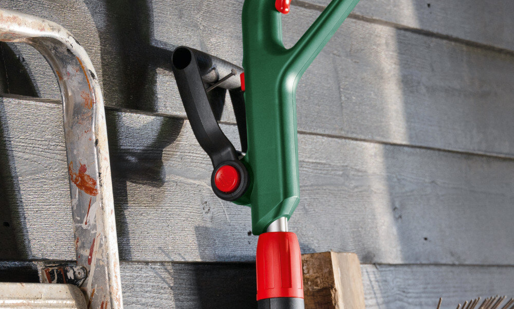 Podkaszarka akumulatorowa BOSCH EasyGrassCut 18V-230 0.600.8C1.A06 ściana zbliżenie na uchwyt podkaszarka zawieszona na gwoździu wygodne przechowywanie otwór w obudowie oszczędność miejsca porządek narzędzie pod ręką bezpiecznie odłożone zabezpieczone przed uszkodzeniem wilgocią od podłoża