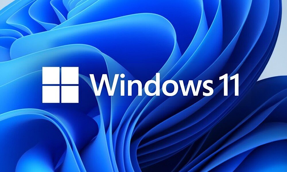 Komputer MAD DOG COUGAR-UNIFACE-I01WR32WH Oficjalne logo systemu operacyjnego Windows 11 na tle abstrakcyjnej, niebieskiej grafiki