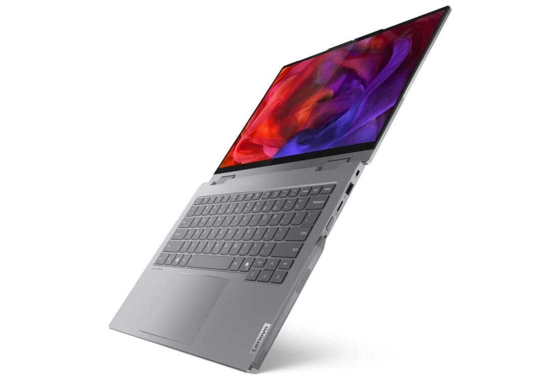 Laptop Lenovo ThinkBook 14 2-in-1 w srebrnej obudowie z ekranem prezentującym abstrakcyjną tapetę w kolorach czerwonym, fioletowym i niebieskim z płynącymi kształtami, widok z góry na klawiaturę i touchpad, podkreślający długi czas pracy na baterii 60 Wh. - zintegrowana bateria 60 Wh