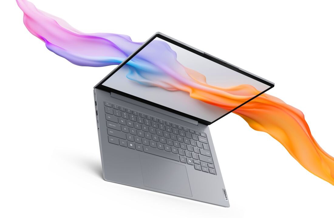 Laptop Lenovo ThinkBook 14 w srebrnej obudowie z artystyczną wizualizacją kolorowych smug farby w odcieniach fioletu i pomarańczy, wypływających z ekranu na białym tle, symbolizujący kreatywność i jakość wyświetlacza. - Opis serii ThinkBook
