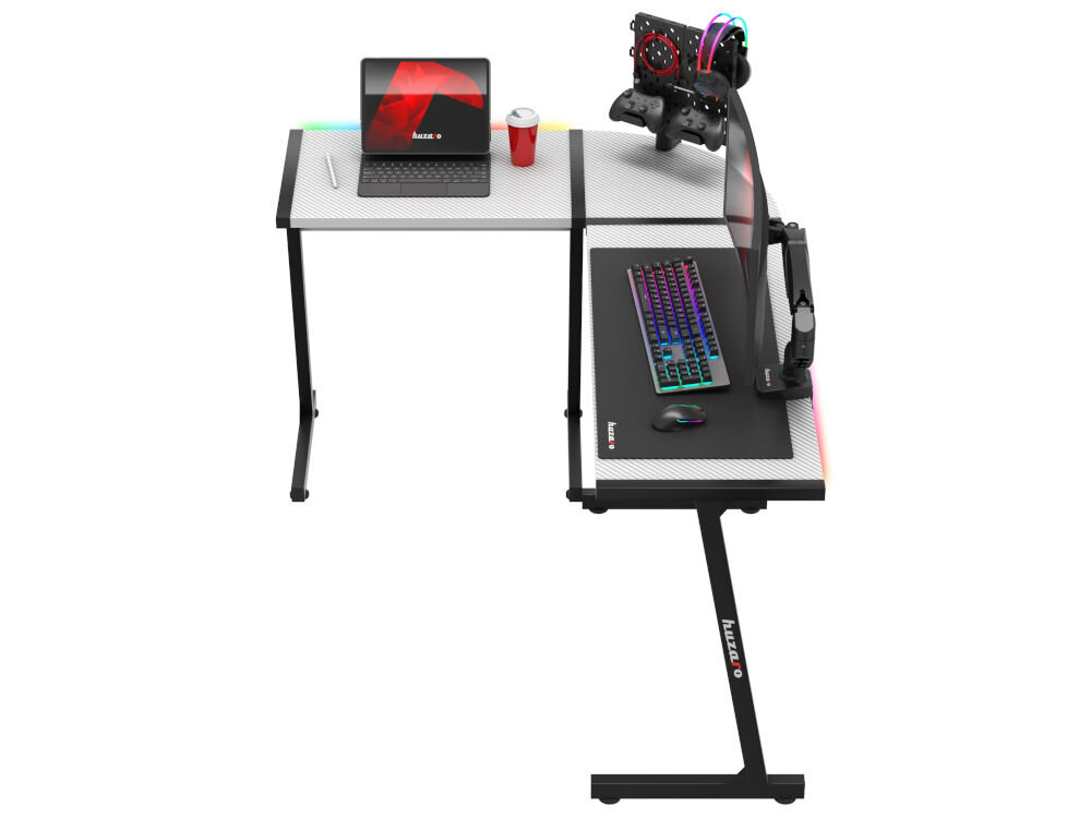 Biurko gamingowe HUZARO Hero 6.0 RGB Biały prezentacja biurka z akcesoriami na białym tle stelaż ze stali wzmocnione nogi szeroka rama stabilność regulowane stopki wypoziomowanie na różnych powierzchniach eliminuje chybotanie