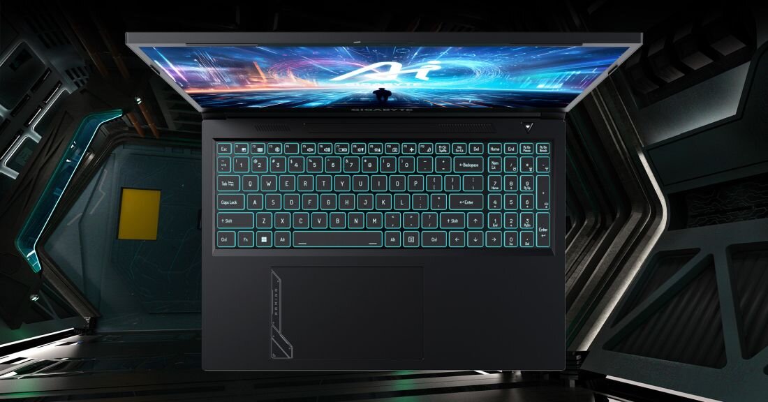 Laptop GIGABYTE G6 widziany z góry z podświetlaną klawiaturą RGB w kolorach niebieskim i turkusowym na ekranie wyświetlającym futurystyczną grafikę z efektami świetlnymi - Klawiatura z oświetleniem RGB