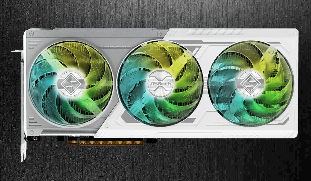 Karta graficzna ASROCK Radeon RX 9070 XT Steel Legend 16GB Widok od frontu na kartę graficzną z trzema wentylatorami z kolorowym podświetleniem. Karta ma białą obudowę o geometrycznych kształtach, wentylatory, chłodzenie, wentylacja