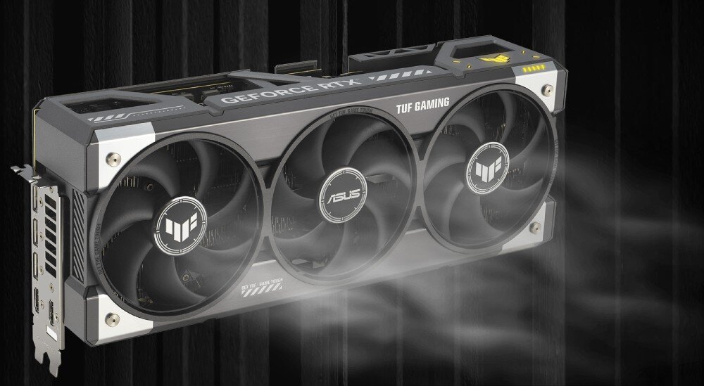 Karta graficzna ASUS GeForce RTX 5090 TUF Gaming 32GB Model karty na ciemnym tle z wizualnym efektem chłodzenia, symbolizującym przepływ powietrza przez wentylatory. Efekt podkreśla działanie układu chłodzenia Axial-tech