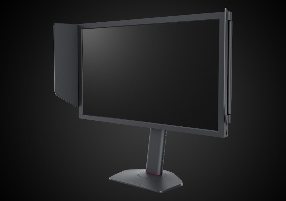Monitor BENQ Zowie XL2586X+ Widok monitora z boku, z zamontowaną osłoną antyodblaskową z obu stron, ustawiony na ciemnym tle, odświeżanie, szybkość matrycy, technologia Adaptive-Sync