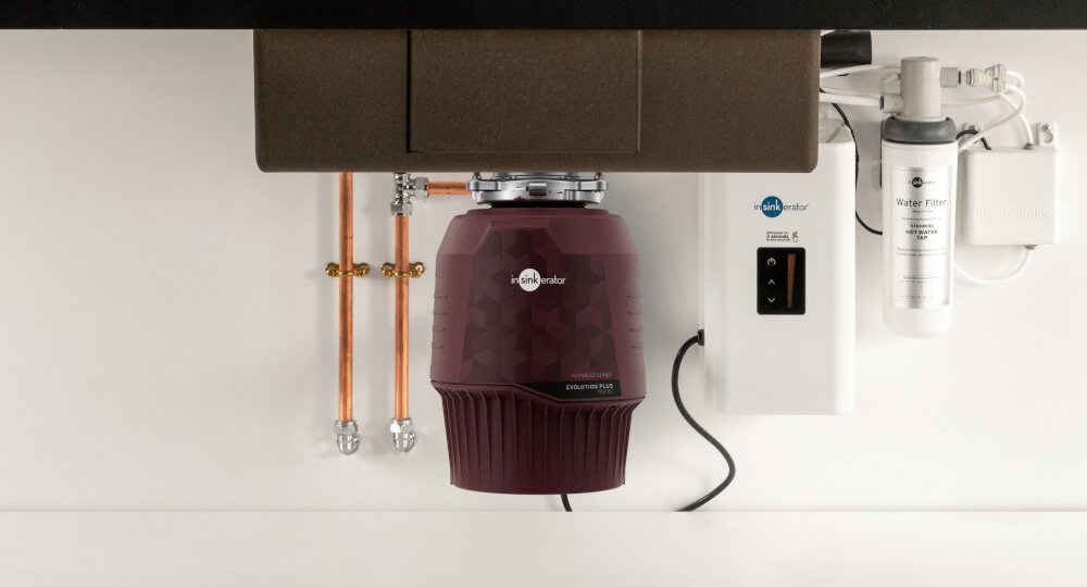 MŁYNEK DO ROZDRABNIANIA ODPADÓW INSINKERATOR EVOLUTION PLUS Rozdrabniacz odpadów zamontowany pod zlewem obok filtra wody i instalacji hydraulicznej. W tle widoczne są miedziane rurki oraz elementy systemu filtracji wentylowana wyjmowana wkładka łatwe czyszczenie i odprowadzanie wilgoci trzystopniowe MultiGrind precyzyjne rozdrabnianie odpadów twardsze i włókniste resztki