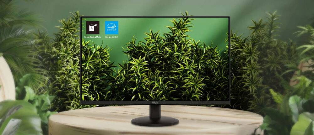 Monitor MSI Pro MP242L 23.8 cala 1920x1080px IPS 100Hz 1 ms [MPRT] pokazanie monitora wśród zielonych liści na stoliku zielona ściana Energy Star 8.0 tryb oszczędzania energii redukcja zużycia prądu dbanie o planetę