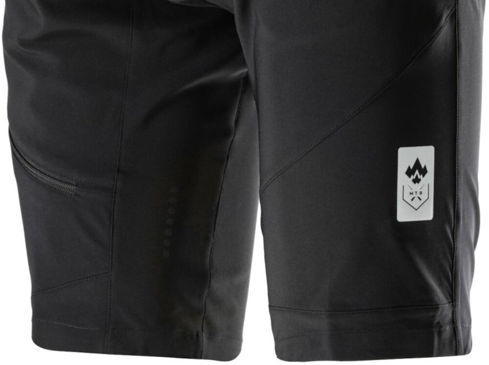 Spodenki rowerowe KROSS MTB Foret (rozmiar XL) Szary zbliżenia na dół nogawek widok na odblask elementy odblaskowe zwiększają widoczność rowerzysty bezpieczniej