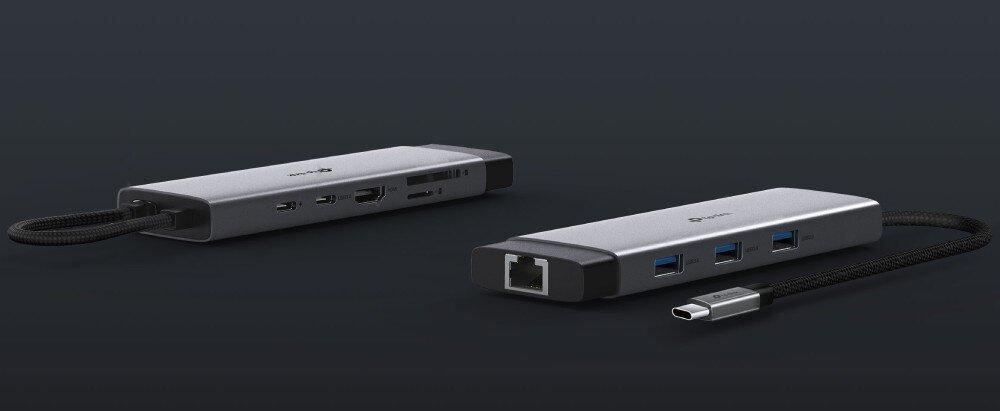 Hub TP-LINK UH9120C Dwa szare adaptery wieloportowe pokazane z różnych stron, prezentujące rozmieszczenie gniazd USB, HDMI, czytnika kart oraz portu ethernet