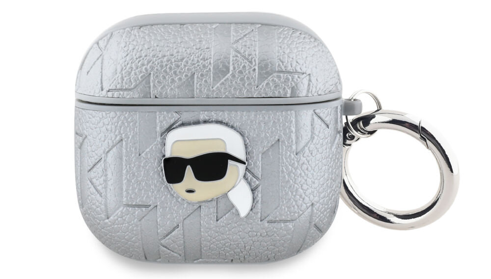 Srebrne etui na słuchawki z teksturą i wytłoczonym wzorem, ozdobione emblematem przedstawiającym postać w okularach przeciwsłonecznych. Etui posiada metalowy pierścień do mocowania.
