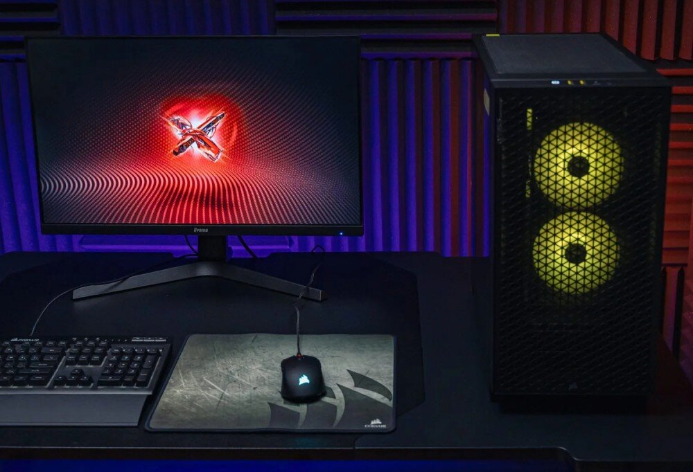 Komputer OPTIMUS E-Sport GA520T-CR5 Zestaw komputerowy na biurku: monitor z czerwoną grafiką na ekranie, klawiatura, myszka na podkładce i obudowa z dwoma frontowymi wentylatorami w kolorze żółtym, podzespoły, cechy, zalety