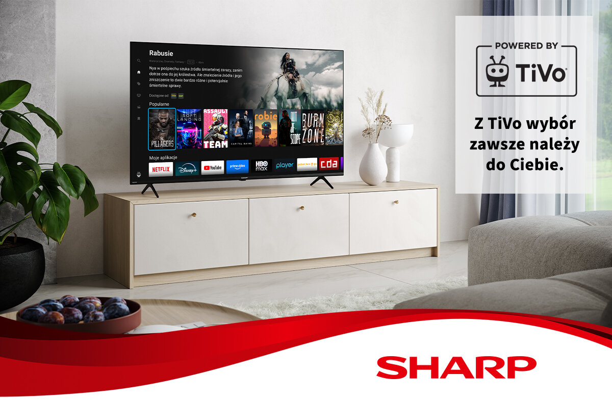Telewizor SHARP 70GK4745E 70\ LED 4K wyświetla interfejs z aplikacjami takimi jak Netflix, YouTube i HBO max. Obok telewizora znajduje się napis \'Z TiVo wybór zawsze należy do Ciebie.\' oraz logo TiVo i SHARP.
