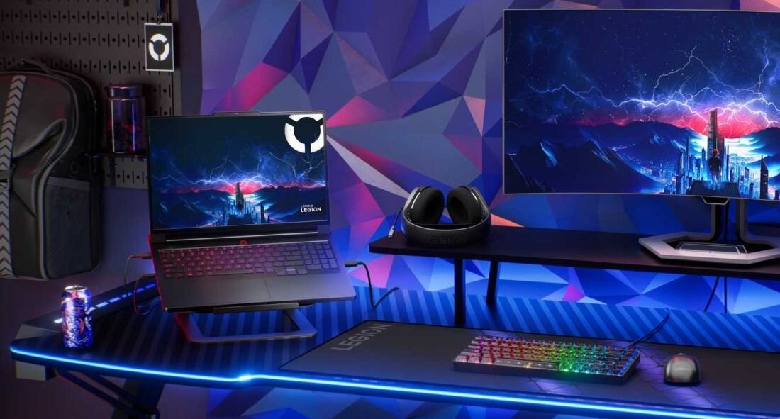 Laptop LENOVO Legion Pro 7 - Biurko gamingowe z monitorem, klawiaturą i myszką, obok laptop LENOVO Legion Pro 7. Wydajność z DDR5 i SSD