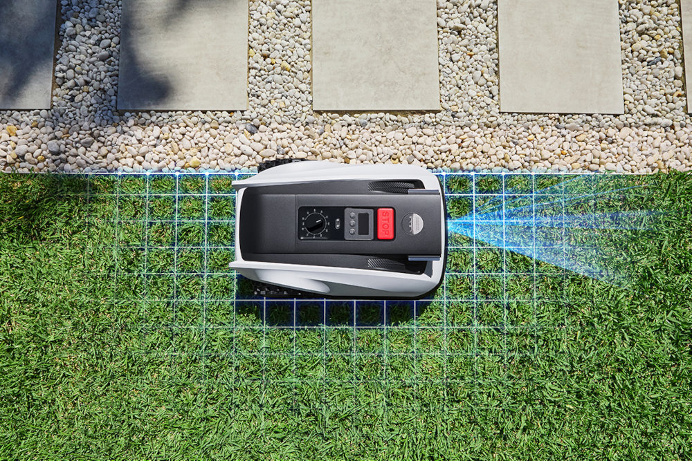 Robot koszący ECOVACS Goat O800 RTK Czarno-biały robot na trawie w tle taras koszenie bez wysiłku automatyczne koszenie trawy innowacyjne koszenie wygodne rozwiązanie