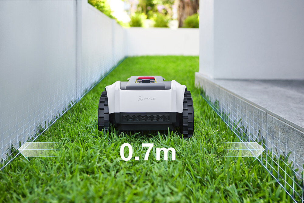 Robot koszący ECOVACS Goat O800 RTK Czarno-biały robot na ścieżce strzałki pokazujące szerokość ścieżki wymiary 60 x 40 x 27 cm system wykrywania krawędzi koszenie w wąskich ścieżkach o szerokości do 0,7 metra 30% lepsza wydajność technologia TruEdge robot dociera do samych krawędzi trawnika inteligentny system oszczędza Twój czas