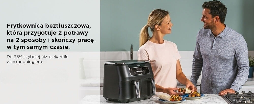 Air Fryer Frytkownica beztłuszczowa NINJA AF200EU z podwójnym koszem kuchenne tło kobieta mężczyzna uśmiechnięci tortille na talerzach frytkownica na blacie czarna obudowa przyciski dwa kosze szybsze – nawet o 75% oszczędność czasu szybsze przygotowanie ulubionych dań testy na paluszkach rybnych i kiełbaskach szybkość wygoda bez nadmiaru tłuszczu