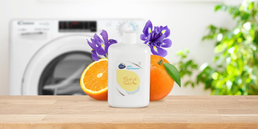 PERFUMY DO PRALKI CARE+PROTECT zdjęcie lifestyle butelka kwiaty pralka w tle zieleń roślina świeżość słodka pomarańcza aromat talku pudrowy irys florencki kumaryna