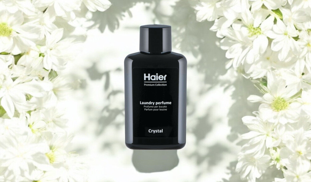 Perfumy do prania HAIER Crystal HPCC10 100 ml zdjęcie lifestyle wizualizacja produktu opakowanie butelka front białe kwiaty jasne tło Zmysłowa świeżość prania Orzeźwiająca mork bryza soczysta słodka pomarańcza zielone nuty trwałość głębia róża damasceńska białe kwiaty Aktywna świeżość nierozpuszczalna formuła stopniowe uwalnianie Skoncentrowana intensywność zmiękczanie tkanin bez plam