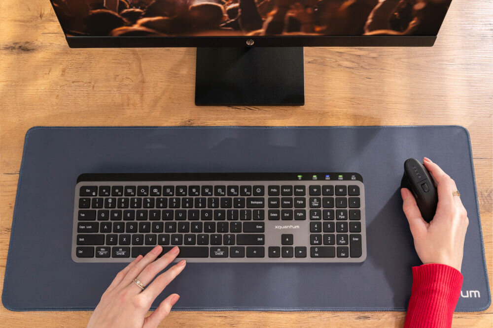 KLAWIATURA XQUANTUM WK500K Wireless dłonie położone na klawiaturze przycisk AI szybki dostęp do funkcji inteligentnych