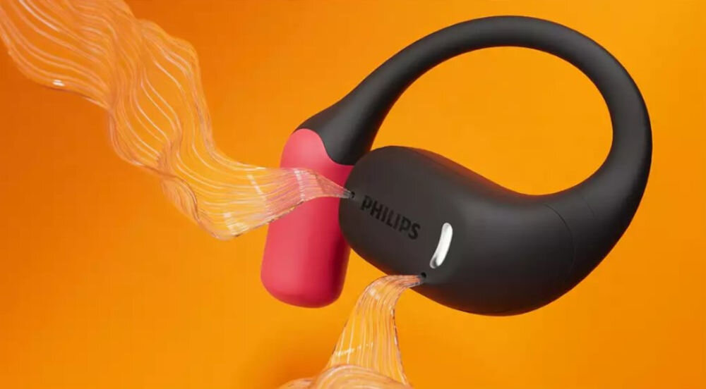 Słuchawki powietrzne PHILIPS TAA6709BK/00 mikrofony AI redukcja szumów wyraźne rozmowy, słuchawka z której wydobywa się dźwięk na pomarańczowym tle