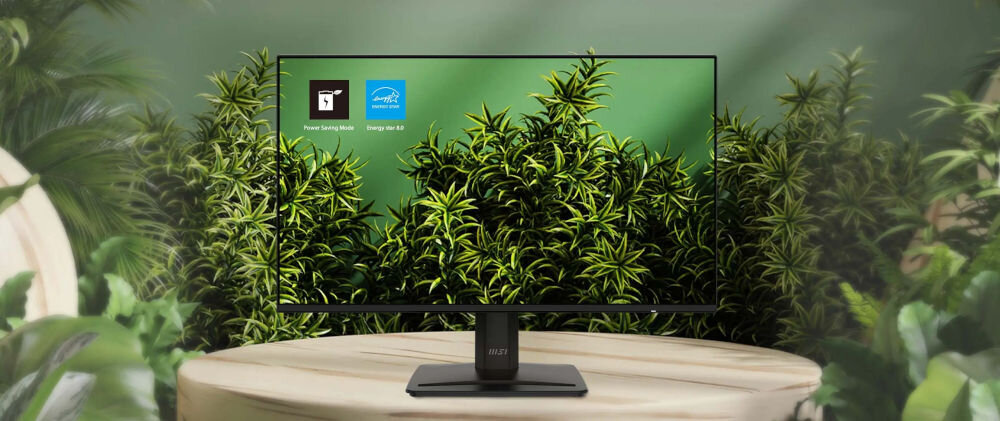 Monitor MSI Pro MP242A E2 23.8 cala 1920x1080px IPS 120Hz 1 ms [MPRT] pokazanie monitora wśród zielonych liści na stoliku zielona ściana Energy Star 8.0 tryb oszczędzania energii redukcja zużycia prądu dbanie o planetę