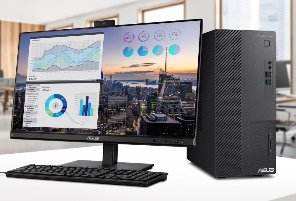 Komputer ASUS ExpertCenter D500ME-513500342X Komputer stacjonarny z monitorem ustawiony na biurku w nowoczesnym biurze, na ekranie wyświetlane są wykresy i dane sprzedażowe na tle panoramy miasta, opis