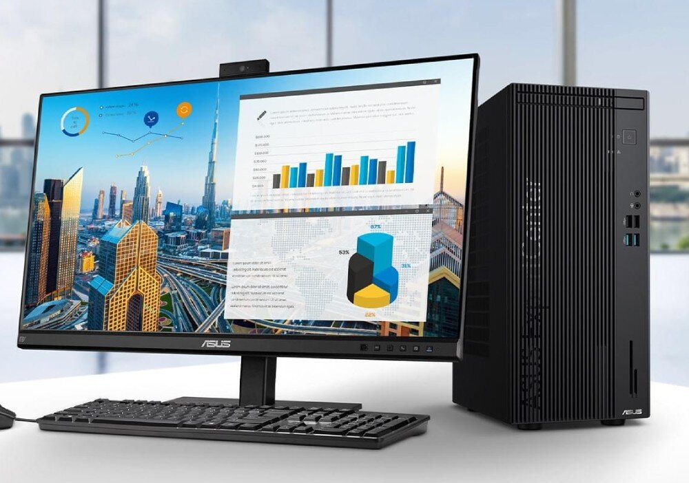 Komputer ASUS ExpertCenter D501MER-514500009X Zestaw komputerowy z monitorem, klawiaturą i jednostką centralną prezentujący wykresy na ekranie w biurowym wnętrzu z widokiem na miasto, podzespoły, procesor, pamięć, wydajność