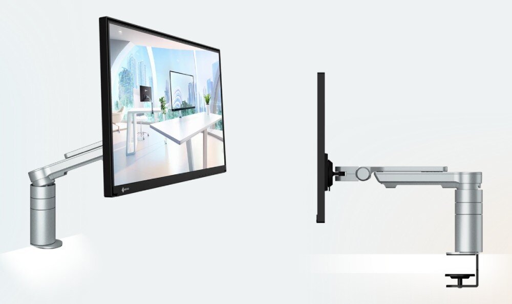 Monitor EIZO FlexScan FLT-BK Monitor zamocowany na ramieniu przymocowanym do biurka. Zdjęcie pokazuje ekran z lekkiego kąta i z profilu, uwidaczniając konstrukcję ramienia montażowego, ramię, regulacja, ergonomia