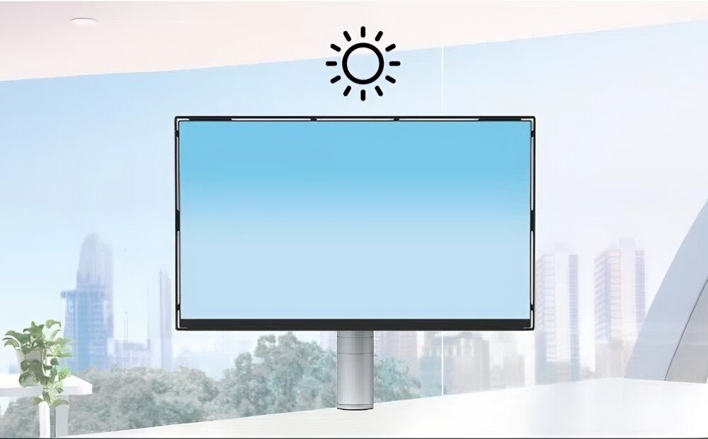 Monitor EIZO FlexScan FLT-BK Monitor na jasnym tle, z grafiką przedstawiającą stopniowe przejście kolorów niebieskiego. Nad ekranem ikona słońca symbolizująca działanie czujnika światła, tryb Eco, jasność