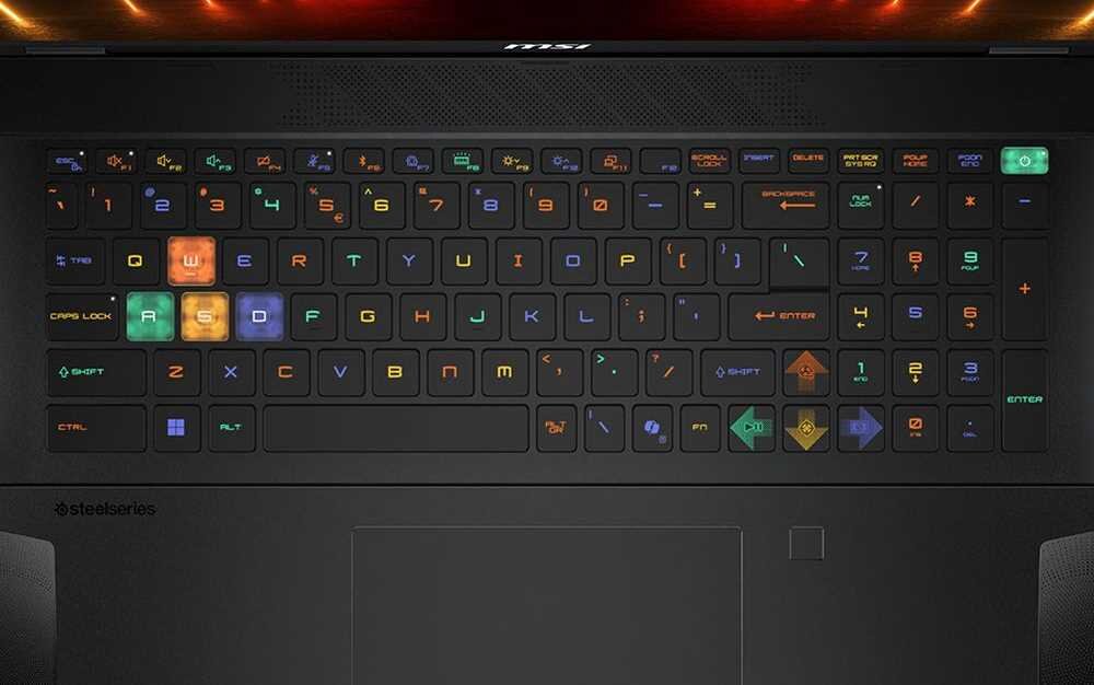 Laptop z wielobarwną klawiaturą RGB firmy SteelSeries z ekranem skierowanym w stronę użytkownika. Gamingowa klawiatura z podświetleniem RGB firmy SteelSeries