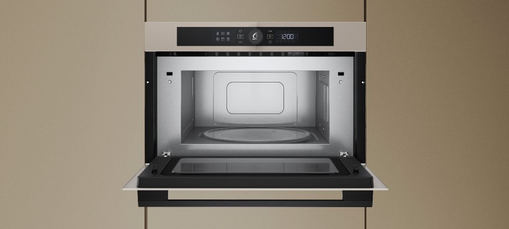 KUCHNIA MIKROFALOWA WHIRLPOOL WMD54MBG lifestyle front otwarta wnętrze wykonanie design panel pokrętło cechy dodatkowe możliwości funkcje Pokrętło 6. Zmysł 7 poziomów mocy Design - kolor szampański Wnętrze stal nierdzewna pojemna komora pojemność 31 L