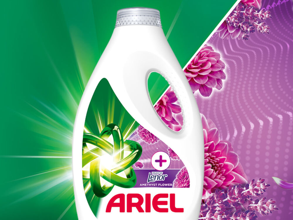 Płyn do prania ARIEL Touch of Leonor Amethyst Flower 2250 ml do kolorowych tkanin Biała butelka płynu do prania ARIEL Touch of Leonor Amethyst Flower z zielonym symbolem atomu na tle rozchodzących się promieni świetlnych