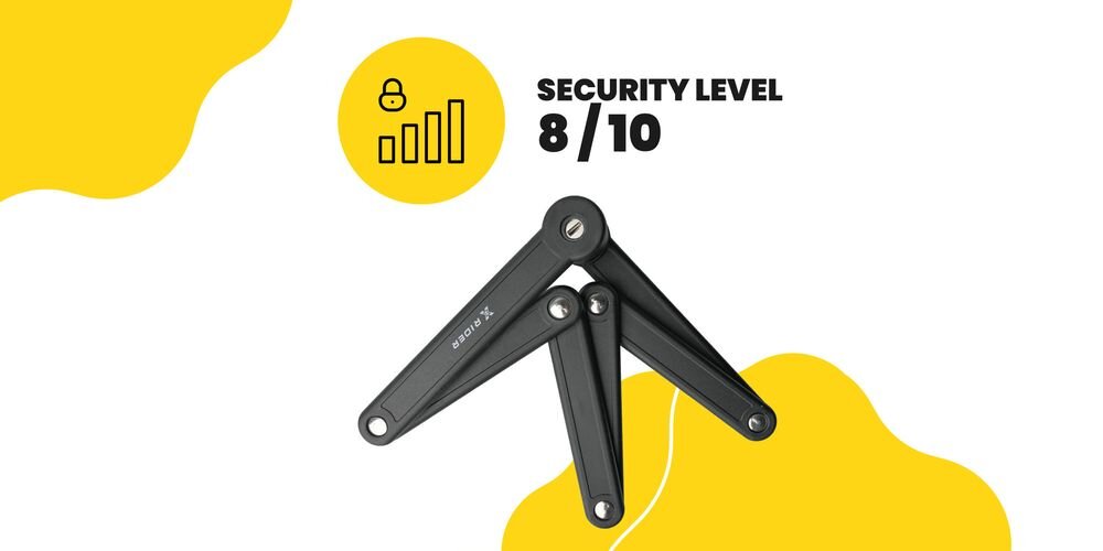 Na obrazie widoczne jest składane zapięcie XRIDER z napisem \'XRIDER\' oraz informacja \'SECURITY LEVEL 8/10\'. Tło jest białe z żółtymi elementami graficznymi.