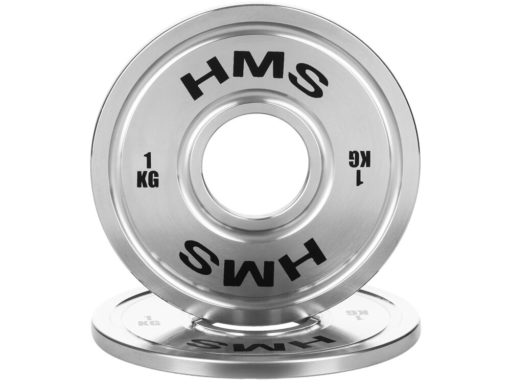 Obciążenie HMS TOS10 (1 kg) obciążenie na białym tle widoczne od przodu ustawione na drugim obciążeniu obciążenie olimpijskie o masie 1 kg wspiera precyzyjne budowanie siły i techniki stopniowe zwiększanie obciążenia bez gwałtownych przeskoków ułatwia kontrolę postępów i zmniejsza ryzyko przeciążenia