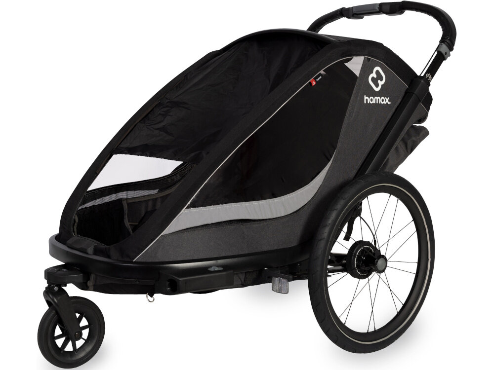 Przyczepka rowerowa HAMAX Cocoon Twin Szaro-czarny przyczepka na białym tle widoczna od przodu pod skosem Zamykane ramię rowerowe zestaw do transportu za rowerem możliwość przechowywania ramienia pod wózkiem Innowacyjny uchwyt rowerowy Zdejmowane koła konstrukcja przygotowana do różnych trybów użytkowania