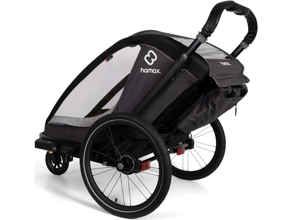 Przyczepka rowerowa HAMAX Cocoon Twin Szaro-czarny przyczepka na białym tle widoczna od tyłu pod skosem Maksymalna waga dzieci wynosi do 22 kg waga całkowita dziecka i bagażu to 42 kg Maksymalny wzrost dziecka określono na 117 cm minimalny wiek użytkownika w trybie rowerowym to około 9 miesięcy dziecko musi samodzielnie siedzieć zatwierdzony zgodnie z EN15918 i EN1888 Koła z odblaskowymi paskami lampka Presto z baterią CR2032