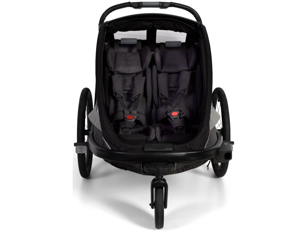 Przyczepka rowerowa HAMAX Cocoon Twin Szaro-czarny przyczepka na białym tle widoczna od przodu 5-punktowa uprząż stabilizuje dziecko w siedzisku właściwą pozycję Aluminiowa rama z pałąkiem zabezpieczającym nisko położony środek ciężkości Kierownica wyposażona w zabezpieczenie przed przewróceniem